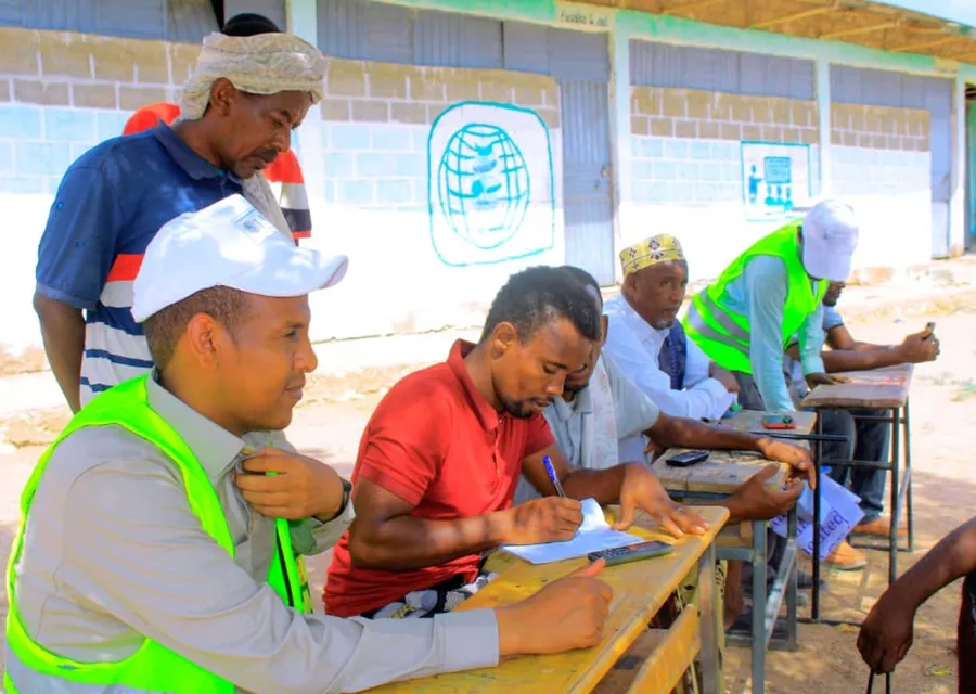 Trainees write at desks outdoors during a HARO skills training session