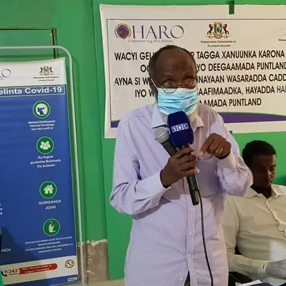 A speaker with a BBC microphone at a HARO COVID-19 awareness event in Puntland, 2020
