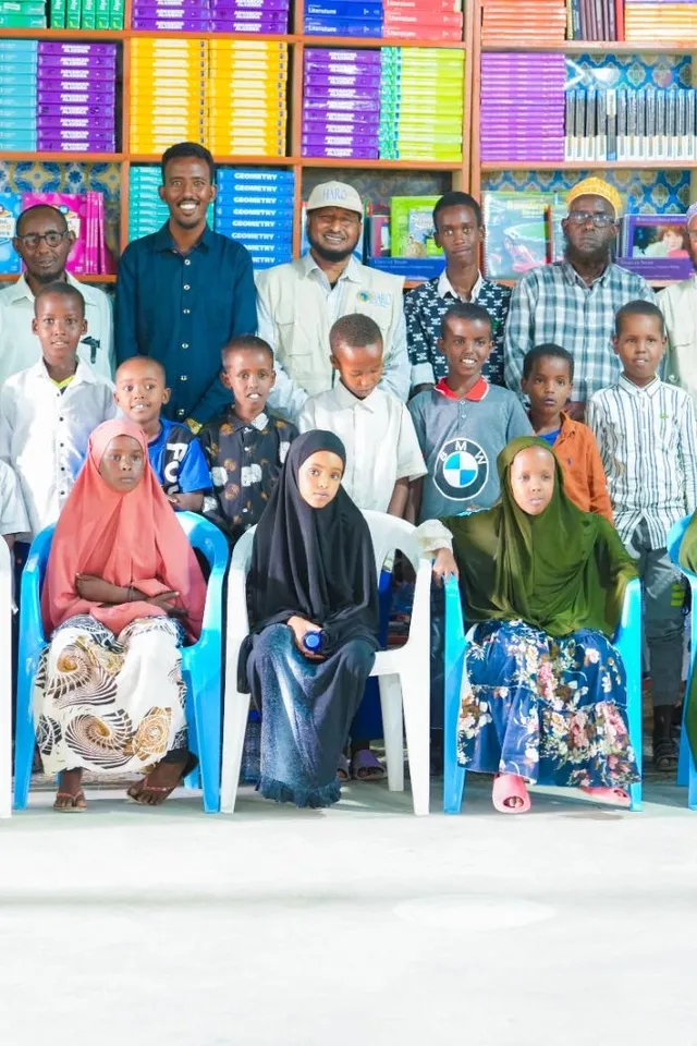 Children with HARO staff in a school library