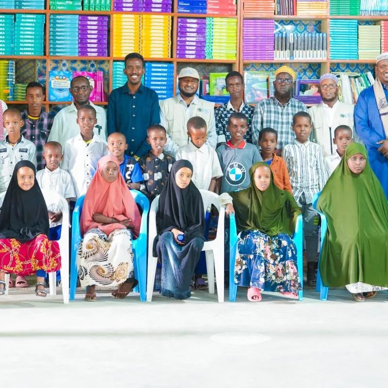 Children in HARO's Orphan Care program with staff in a library