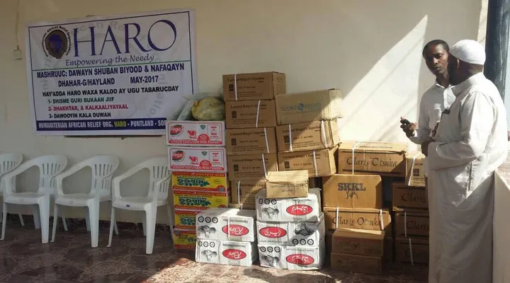 Boxes of donated medicines and IV fluids beside the HARO project banner at Dhahar Hospital, 2017