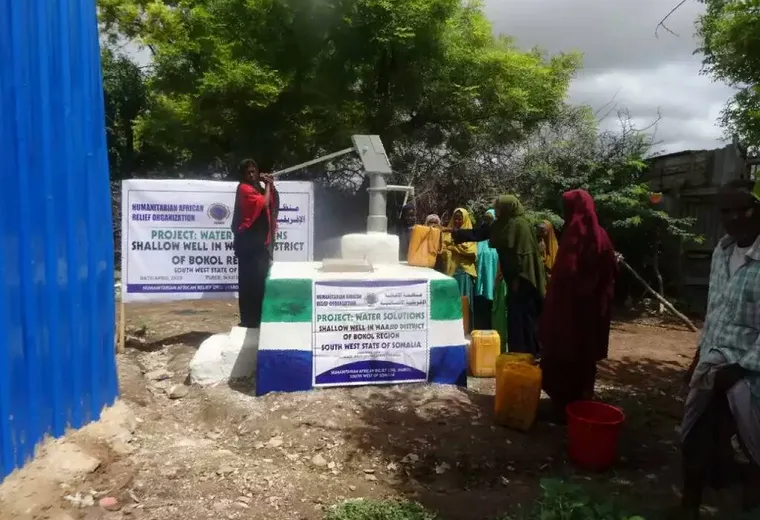 Women collect water at the completed HARO shallow well in Wajid District, Bakool, 2018