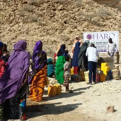 Women and children queue with jerry cans at a HARO water solution in Tuur village, Eyl