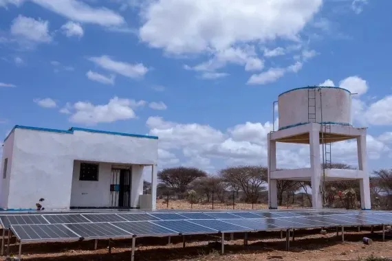 Solar panels power the pump house and elevated water tank of a HARO solar water system